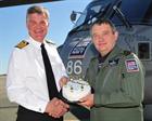 Lt Cdr Roger Moffatt  receives cake from Capt Mark Garratt, CO Culdrose