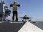 The Petty Officer of the Deck marshals the F-35 into position