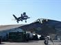 An Italian F-35 lifts of the ramp with a USMC Lightning parked in the foreground
